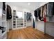 Large walk-in closet with custom shelving, ample storage space, and hardwood floors at 2713 Trifle Lane Ln, Wake Forest, NC 27587