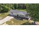 Overhead angle displays a well-kept ranch home with a long driveway and a large, landscaped yard surrounded by lush trees at 282 Cooke Rd, Louisburg, NC 27549