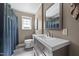Updated bathroom with modern vanity, sink, and fixtures with a full length mirror at 282 Cooke Rd, Louisburg, NC 27549