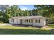 Charming single story home boasts a large front yard, covered porch, and classic curb appeal in a tranquil setting at 282 Cooke Rd, Louisburg, NC 27549