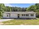 This inviting single-story home features a covered porch, a well-maintained lawn, and a classic, welcoming facade at 282 Cooke Rd, Louisburg, NC 27549
