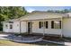 The covered front porch, bay window, and landscape lighting highlight the charm of this beautiful, single-story home at 282 Cooke Rd, Louisburg, NC 27549