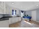 Bright kitchen with white cabinets, tile flooring, and cozy breakfast nook at 282 Cooke Rd, Louisburg, NC 27549