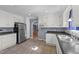 Functional kitchen features white cabinetry, tile floor, and black refrigerator at 282 Cooke Rd, Louisburg, NC 27549