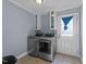 Efficient laundry room with modern washer, dryer, and ample cabinet space at 282 Cooke Rd, Louisburg, NC 27549