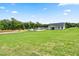 Large backyard view showcasing a spacious lawn with potential for landscaping and outdoor activities at 303 Rothbury Ct, Sanford, NC 27330