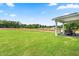 Expansive backyard with lush green lawn and covered patio, perfect for outdoor relaxation and entertainment at 303 Rothbury Ct, Sanford, NC 27330