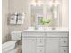 Bathroom featuring double vanity with white cabinets, framed mirrors, modern fixtures, and a toilet at 303 Rothbury Ct, Sanford, NC 27330