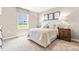 Comfortable bedroom with a queen bed, neutral walls, carpet, and side tables, providing a relaxing atmosphere at 303 Rothbury Ct, Sanford, NC 27330