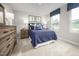 Cozy bedroom featuring a large window, plush carpet, blue accents, and stylish furnishings at 303 Rothbury Ct, Sanford, NC 27330