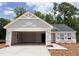 Charming home featuring an attached two-car garage and a light-filled design at 303 Rothbury Ct, Sanford, NC 27330