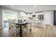 Open-concept kitchen and dining area featuring stainless steel appliances, a breakfast bar, and stylish seating at 303 Rothbury Ct, Sanford, NC 27330