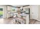 Modern kitchen featuring stainless steel appliances, granite countertops, and a breakfast bar with seating at 303 Rothbury Ct, Sanford, NC 27330