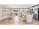 Open-concept kitchen featuring stainless steel appliances, granite countertops, and an adjacent dining area at 303 Rothbury Ct, Sanford, NC 27330
