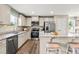 Modern kitchen featuring stainless steel appliances, granite countertops, and a breakfast bar with seating at 303 Rothbury Ct, Sanford, NC 27330