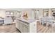 Open-concept living space featuring a kitchen island with granite countertops and stainless steel appliances at 303 Rothbury Ct, Sanford, NC 27330