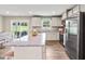 Modern kitchen featuring stainless steel appliances, granite countertops, and a breakfast bar with seating at 303 Rothbury Ct, Sanford, NC 27330