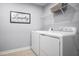 Practical laundry room equipped with modern washer, dryer, and storage shelves for convenience at 303 Rothbury Ct, Sanford, NC 27330