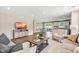 Inviting living room featuring hardwood floors, modern furniture, and an open layout to the dining and kitchen areas at 303 Rothbury Ct, Sanford, NC 27330