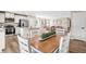 Open-concept living space featuring a kitchen with a breakfast bar and a cozy living room with comfortable seating at 303 Rothbury Ct, Sanford, NC 27330