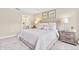 Bright main bedroom with a large bed and ensuite bathroom featuring carpet flooring and neutral walls at 303 Rothbury Ct, Sanford, NC 27330