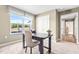 Well lit office space with large windows, neutral walls, and a dark wood desk and tan chair at 303 Rothbury Ct, Sanford, NC 27330