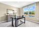 Well lit office space featuring neutral walls, a desk, chair, side board, and a large window at 303 Rothbury Ct, Sanford, NC 27330