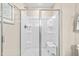 Modern shower with sleek glass doors, built-in bench, and clean, minimalist design at 303 Rothbury Ct, Sanford, NC 27330