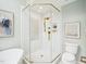 This bathroom has a glass enclosed shower, toilet, and tiled floors at 305 Promontory Point Dr, Cary, NC 27513