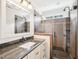 This bathroom features a shower and a granite vanity at 305 Promontory Point Dr, Cary, NC 27513