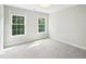 This is a bedroom with a carpet and two windows at 305 Promontory Point Dr, Cary, NC 27513