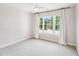 Bright bedroom with neutral carpet, ceiling fan, and window with backyard views at 305 Promontory Point Dr, Cary, NC 27513