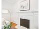 Close up of a fireplace features white brick, herringbone pattern and modern decor at 305 Promontory Point Dr, Cary, NC 27513