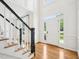 Bright foyer with hardwood floors, staircase, and a clear view to the home's front exterior at 305 Promontory Point Dr, Cary, NC 27513