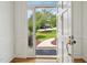 View through the open front door to the landscaped yard and inviting curb appeal at 305 Promontory Point Dr, Cary, NC 27513