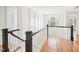 Bright hallway with hardwood floors, decorative moldings, and an elegant chandelier at 305 Promontory Point Dr, Cary, NC 27513