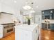 A modern kitchen offers custom white cabinets, a large island, and professional-grade appliances at 305 Promontory Point Dr, Cary, NC 27513