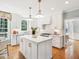 Bright kitchen features an island, white cabinetry, pendant lighting, and modern appliances at 305 Promontory Point Dr, Cary, NC 27513