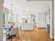 Spacious, all-white kitchen featuring hardwood floors and modern appliances at 305 Promontory Point Dr, Cary, NC 27513
