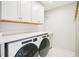 Laundry room with modern appliances and storage at 305 Promontory Point Dr, Cary, NC 27513