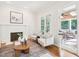 Cozy living room featuring hardwood floors, a fireplace, and view to a bright outdoor patio space at 305 Promontory Point Dr, Cary, NC 27513