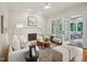 Bright living room with fireplace, seating, and access to screened porch at 305 Promontory Point Dr, Cary, NC 27513