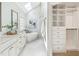 Luxurious main bathroom with double vanity, soaking tub, glass enclosed shower and walk-in closet at 305 Promontory Point Dr, Cary, NC 27513