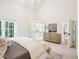 Light and airy main bedroom with large windows and an ensuite bathroom with dressing area at 305 Promontory Point Dr, Cary, NC 27513