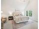 Spacious main bedroom boasts vaulted ceiling, plush carpet, and calming neutral color palette at 305 Promontory Point Dr, Cary, NC 27513