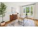 Bright office with a neutral rug, hardwood floors, and a window overlooking the front yard at 305 Promontory Point Dr, Cary, NC 27513