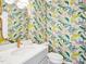 Stylish powder room featuring vibrant peacock wallpaper and a sleek vanity with quartz countertop at 305 Promontory Point Dr, Cary, NC 27513