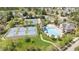 Aerial shot of community amenities, including tennis courts, a swimming pool, and a clubhouse nestled within green spaces at 306 Berlin Way, Morrisville, NC 27560