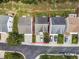 An aerial view shows this home's location within a neighborhood with a driveway and grassy backyard at 306 Berlin Way, Morrisville, NC 27560