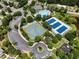 Aerial view showcasing the tennis courts, pool, clubhouse, and playground of a community at 306 Berlin Way, Morrisville, NC 27560